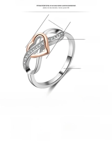 Detail view of heart-shaped ring with infinity symbol and crystals in two-tone finish