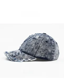 Detailed side view of distressed navy denim baseball cap with fringed edge details