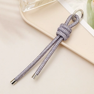 Detail view of purple rhinestone knot charm with silver ring for bags and keys