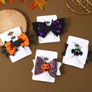 Set of four festive Halloween hair clips with spider webs and pumpkin bow designs