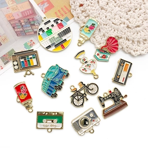 Detailed flat lay of vintage 80s 90s style alloy charms including camera and sewing machine