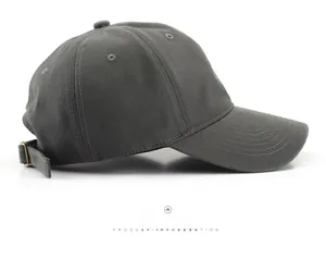 Side view of dark grey washed cotton baseball cap with adjustable metal buckle strap