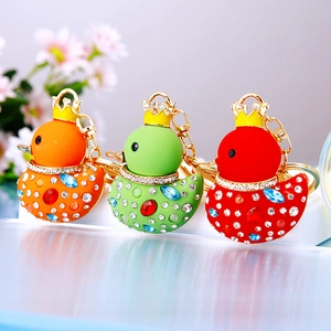 Three creative rhinestone duck keychains with golden crowns in orange, green and red colors