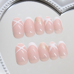 Elegant nude pink press-on nails with French tips and cross-line designs on a mirror