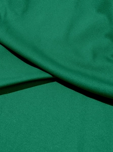 Macro view of green plain weave fabric texture for men's joggers showing high-quality stitching