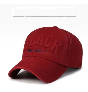 Macro detail of wine red baseball cap with 3D black text and blue embroidery