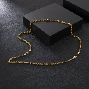 Golden stainless steel O-chain link necklace with lobster clasp on a dark background