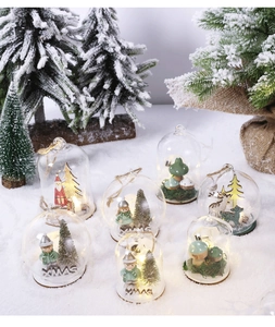Detail of LED Christmas glass globes with Santa and reindeer miniature winter scenes