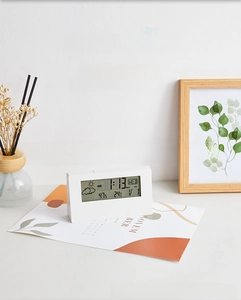 Modern white desk clock with 15-degree ergonomic tilt displaying time and temperature