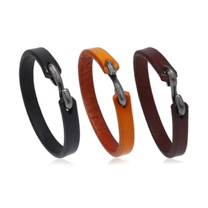 Detailed view of woven leather bracelets in black, orange, and brown with metal S-hooks