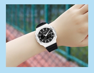 Wrist shot of SANDA dual display watch showing digital time and water resistance detail