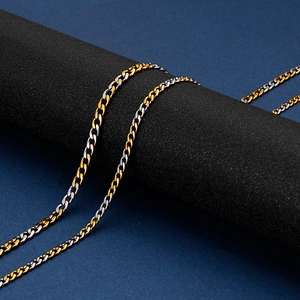 Detail of two-tone gold and silver Cuban chain link necklace on black display stand