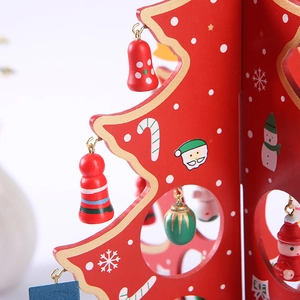 Handcrafted red wooden Christmas tree desktop ornament with snowman and festive miniature toys
