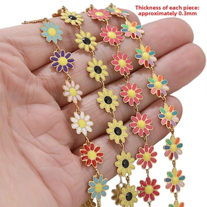 Macro view of 10mm gold stainless steel chain with colorful enamel daisy charms for DIY