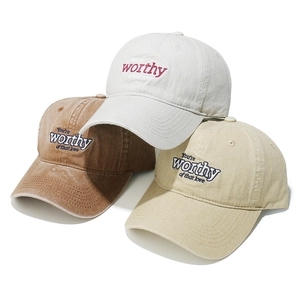 Macro shot of embroidered baseball caps in three colors with washed cotton texture