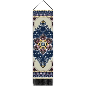 Close-up of woven tapestry featuring symmetrical geometric patterns and black bottom tassels