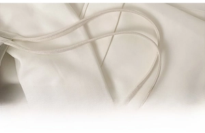 Detail of comfortable ivory canvas shoulder straps with fine woven texture and soft curves