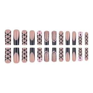 Nude pink long ballerina press-on nails with black bows and rhinestone accents