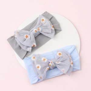Detail of baby headbands with daisy embroidery and mesh bows in grey and light blue