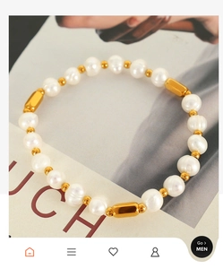 Detailed view of freshwater pearls with gold beads and titanium steel bar charms