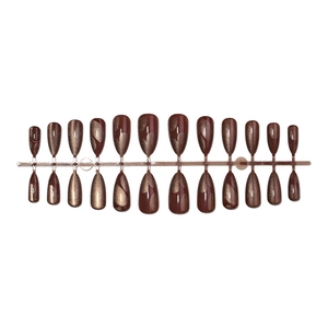 Press-on nail set with dark reddish-brown cat-eye marble texture on white background