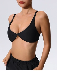 Close-up of black ribbed sports bra featuring a twisted knot detail and thin straps