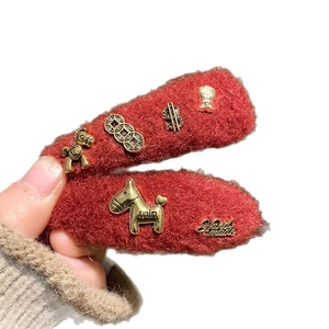 Pair of red plush BB hair clips with gold pony and coin charms for New Year