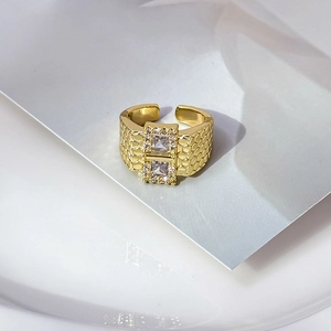 Golden wide open ring with double square zircons and textured honeycomb pattern