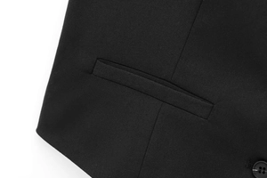Detailed close-up of a black quilted vest featuring a premium welt pocket and sleek fabric texture