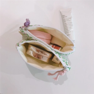 Detail view of floral cotton mini pouches storage capacity for makeup and cosmetics