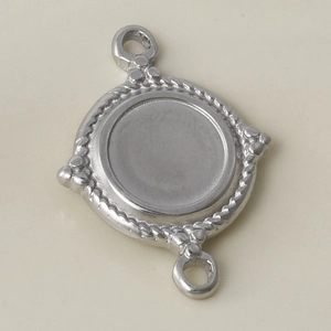 Close-up of silver stainless steel round connector with rope texture and dual loops