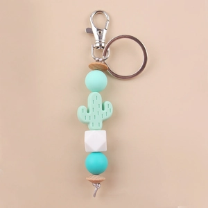 Detail of mint green silicone cactus keychain with wooden beads and silver metal ring