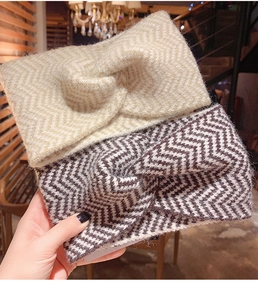 Macro detail of thick chevron knit headbands with stylish twist knot and soft texture