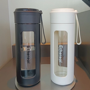 Detail view of black and white high-aesthetic glass water bottles with carry straps