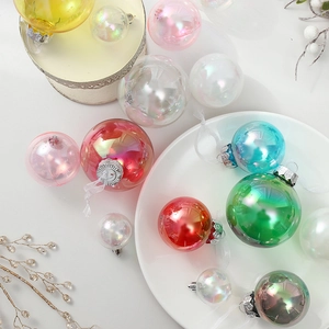 Iridescent Christmas ball ornaments in multiple colors and sizes on a white platter