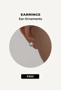 Close-up of elegant white pearl stud earring with gold base on minimalist model view