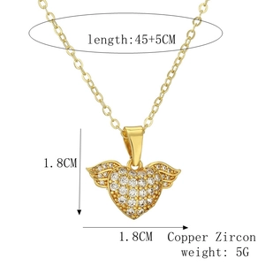 Detail view of gold-plated winged heart pendant with micro-pave cubic zirconia on copper