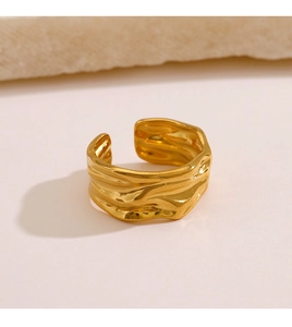 Detailed view of the gold irregular lava texture and metallic luster on the open ring