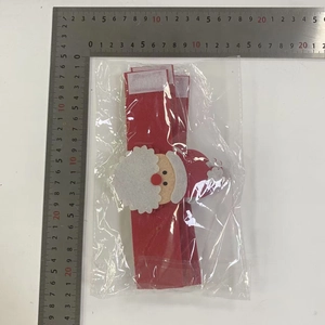 Macro view of Santa Claus non-woven napkin ring measured with a scale in packaging