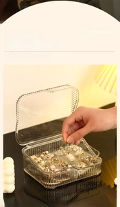 Detail of transparent double-layer jewelry box showing multi-grid interior storage