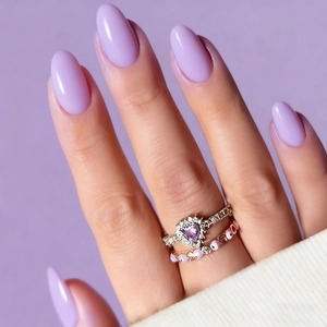 Elegant lavender almond fake nails with matching purple gemstone rings for women