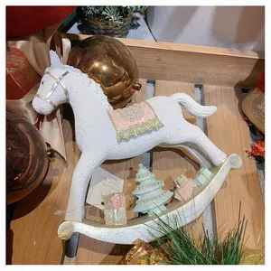 Detail of resin rocking horse ornament with woven texture and mini Christmas tree