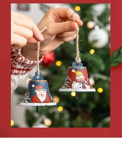 Close-up of vintage metal Christmas bells with hand-painted Santa and Snowman patterns