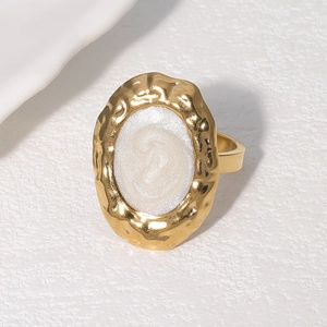 Vintage gold oval ring with textured metal edge and white glitter resin inlay