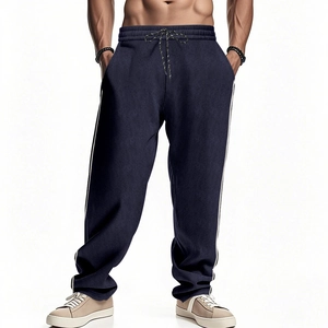 Detailed close-up of navy blue corduroy pants with elastic drawstring waist and side stripes
