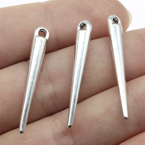Silver cone-shaped metal pendant charms for jewelry making shown on fingertips for size
