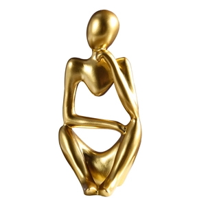 Golden abstract thinker sculpture with a metallic finish for modern office desk decor