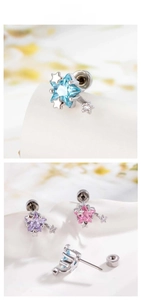 Macro shot of colorful star stud earrings with zirconia stones and screw back details