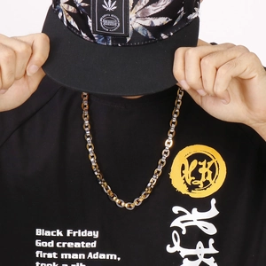 Close-up of thick hip hop chain necklace in mixed gold and silver tones on a model