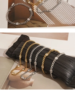 Close-up of gold and silver Cuban chain bracelets with sparkling zircon stones